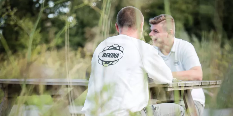 Bekina employees on picnic table 